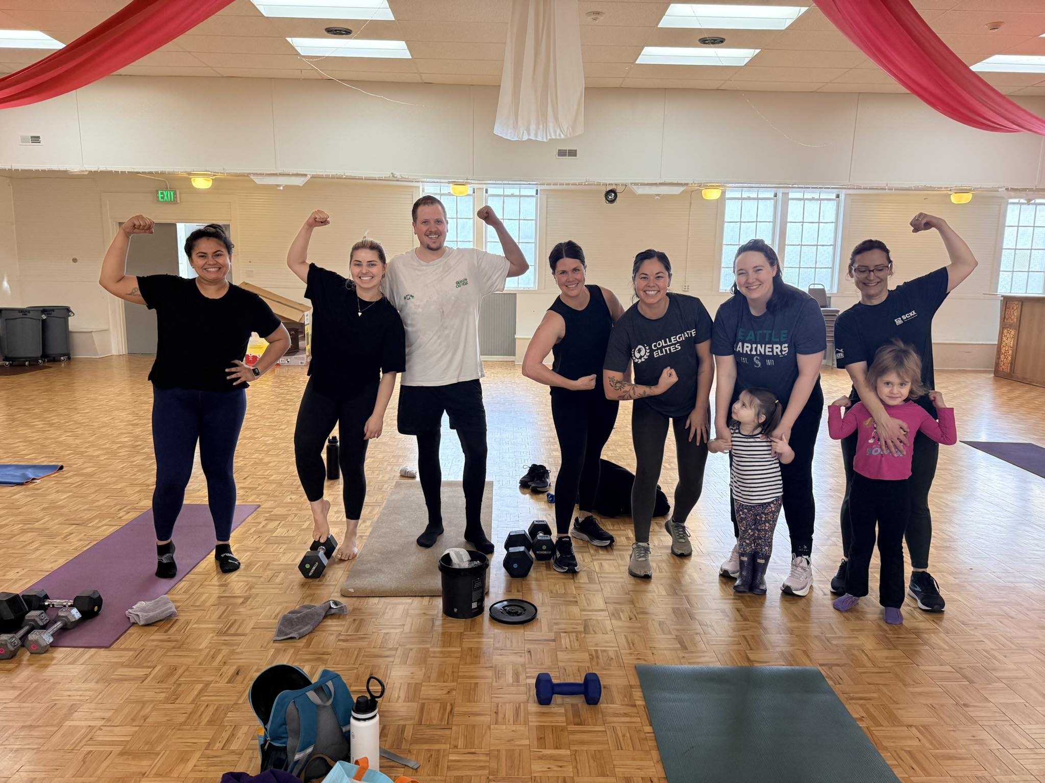 Group of members flexing and celebrating after workout